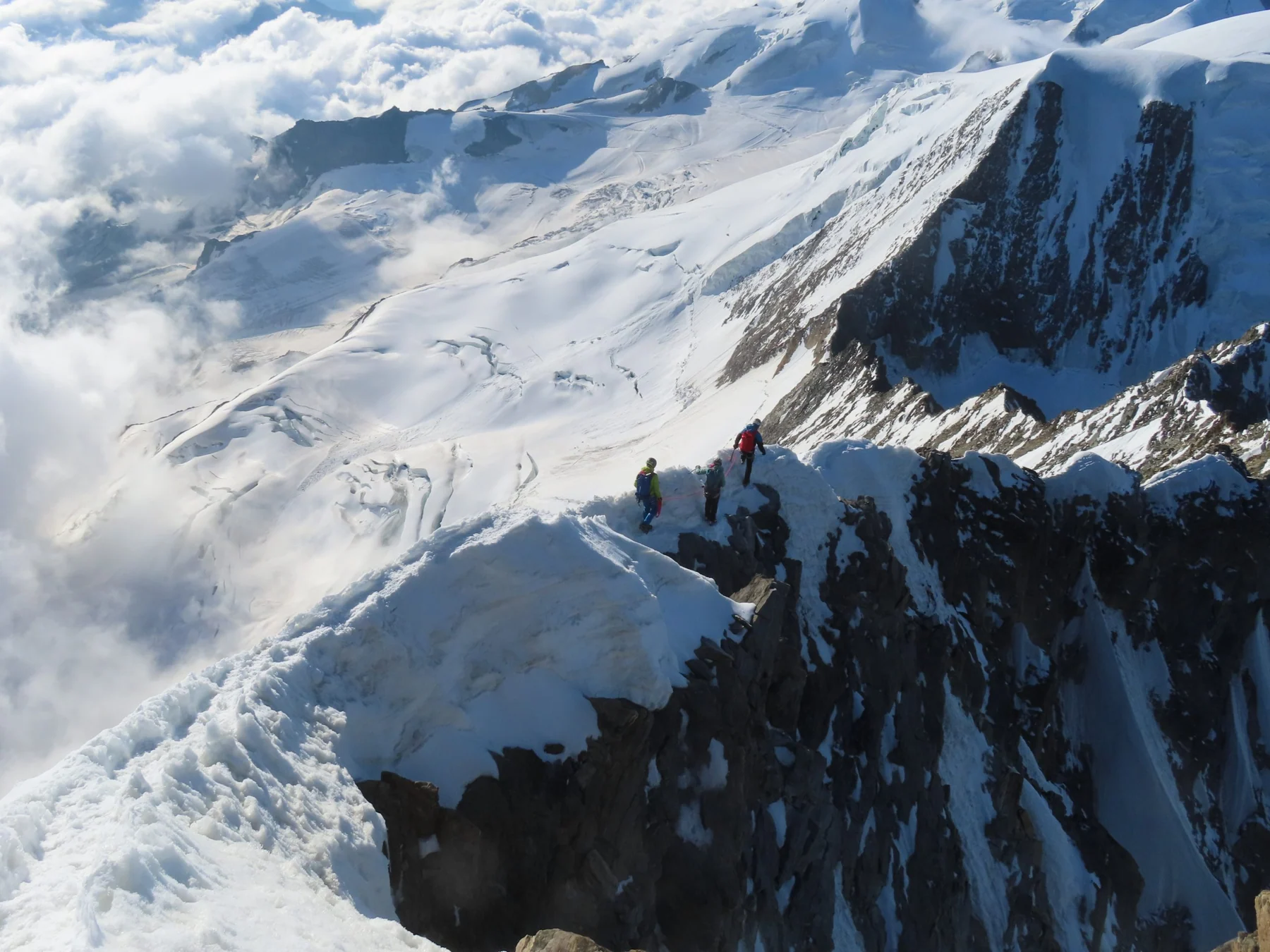 Creste alpine innevate tra le nuvole
